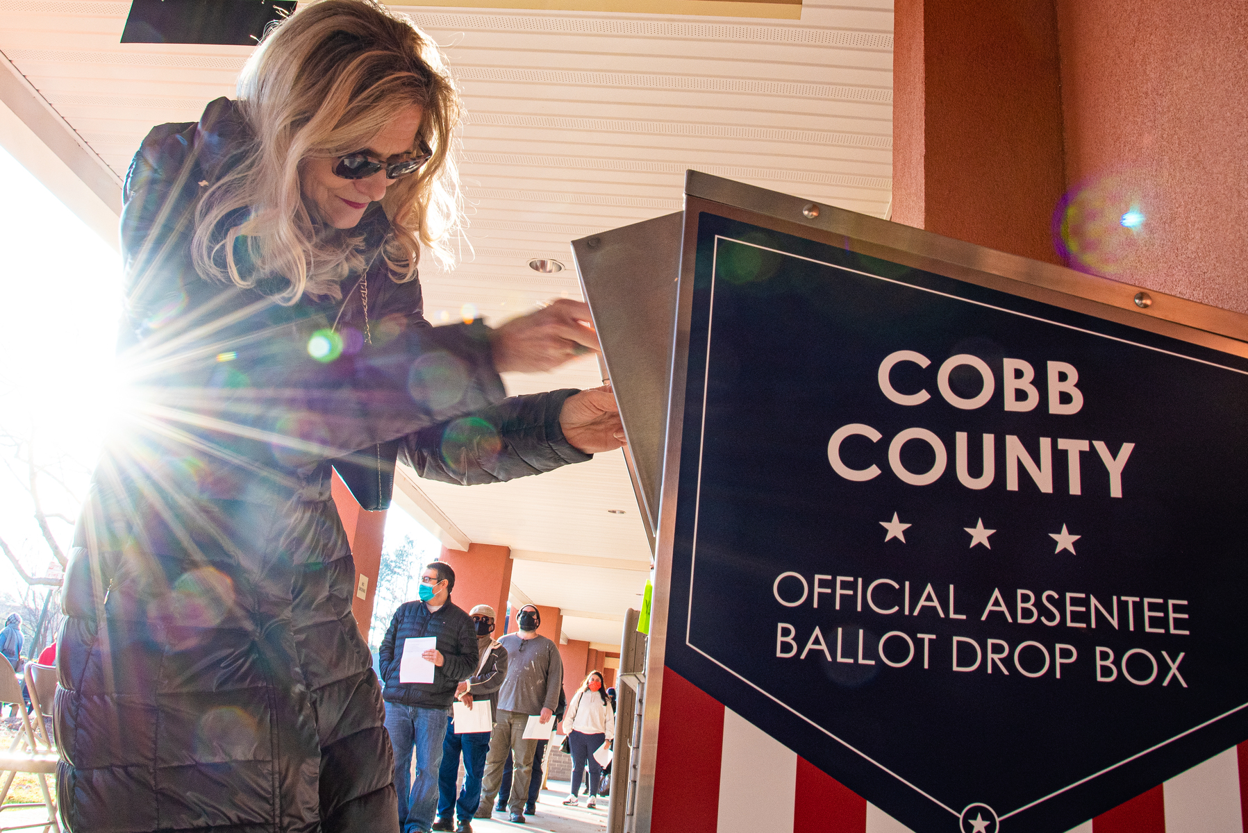 December 17, 2020 – Marietta, GA. A voter drops off a ballot during the U.S Senate run-off race.